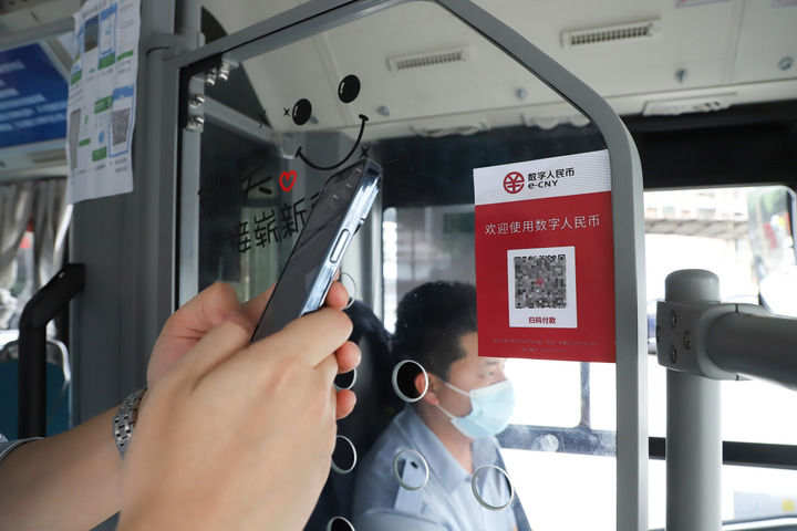 2022年4月29日，在重庆市璧山区，一名乘客使用数字人民币付款乘坐公交车。新华社发